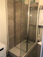 a shower with a glass door in a bathroom at Cocon Rue Ecuyère - Calme- 2ch - 6pers in Caen