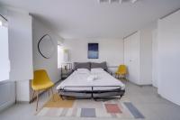 a bedroom with a bed and two yellow chairs at Very lovely apartment Bordeaux in Bordeaux