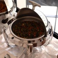 a pot full of food sitting on a table at Sherao Hotel Doha - Next to National Museum of Qatar & Metro - فندق شراعوة الدوحة - بجانب متحف قطر الوطني ومحطة المترو in Doha