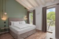 A bed or beds in a room at HT Hotel Trieste