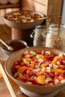 a bowl of fruit sitting on top of a table at Jangal das Araucárias Swan Design Hotel Canela in Canela
