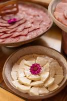 a bowl of food with a flower on top of it at Jangal das Araucárias Swan Design Hotel Canela in Canela
