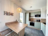 a kitchen with a wooden table in a room at Appartement Calvi, 2 pièces, 4 personnes - FR-1-719-13 in Calvi