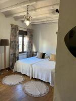 A bed or beds in a room at Casa Rural La Chocolateria