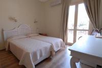 Postel nebo postele na pokoji v ubytování Hotel Karthea