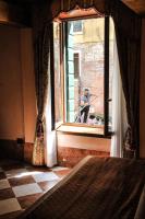 a man sitting in a window looking out of a building at Ca&#39; Amadi in Venice