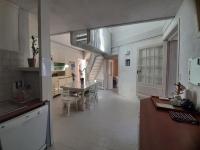 a kitchen and dining room with a table and a staircase at Maison de charme, plage a 300 m Dinard St Enogat in Dinard