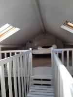 a attic room with a bed and a staircase at Maison de charme, plage a 300 m Dinard St Enogat in Dinard