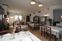 a restaurant with tables and chairs with white tablecloths at Agriturismo Villa Marta in Cesena