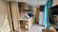 a small kitchen with a sink and a refrigerator at Camping Aux Portes De Cassis in La Bédoule