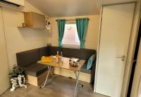 a small dining room with a table and a window at Camping Aux Portes De Cassis in La Bédoule