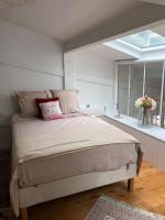 - une chambre avec un lit et une fenêtre fleurie dans l&#39;établissement Appartement cosy esprit loft, à Paris