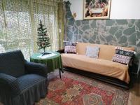 a living room with a couch and a christmas tree at Berkenyés Vendégház in Zalalövő
