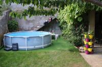 a hot tub sitting in the grass in a yard at Guest House Lejla in Travnik