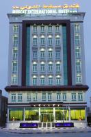 a hotel building with a sign on top of it at Muscat International Hotel Plaza in Salalah