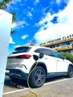 a white car with a yellow hose attached to it at Premiere Classe Perpignan Sud in Perpignan