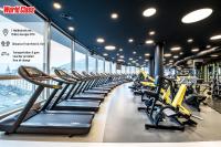 a gym with a row of treadmills at IOTA Hotel Tbilisi in Tbilisi City
