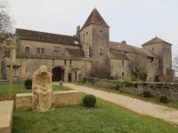 an old building with a statue in front of it at Maison Jean Léone in Gevrey-Chambertin