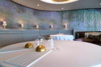 a table in a restaurant with two glasses on it at lebua at State Tower in Bangkok