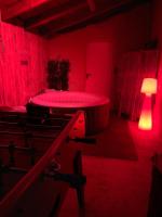 a red room with a tub and a lamp at Maison piscine &amp; spa Vallon Pont d&#39;Arc in Vallon-Pont-dʼArc