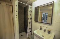 a bathroom with a sink and a shower with a mirror at Au chant du coq in Saint-Lyé