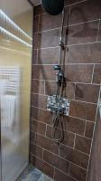 a shower with a hose attached to a brick wall at Aux Écuries Des Pres in Nogent-sur-Seine