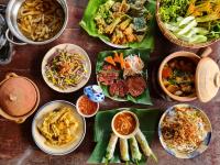 Una mesa con muchos platos de comida encima. en InnerZen Riverside homestay Ben Tre 1 bedroom for 1-2 guests, 2 bedrooms for 3-4 guests, en Ấp Phú Hòa (3)