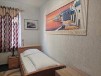 a bedroom with a bed and a painting on the wall at Hotel Restaurant Rhodos in Elsterwerda