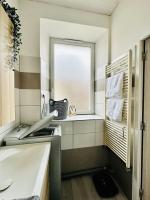 a small kitchen with a window and a sink at Appart. spacieux et lumineux 4 pers. in Morez