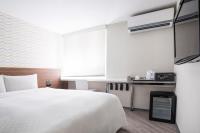 a bedroom with a large white bed and a window at Cityinn Hotel Taipei Station Branch I in Taipei