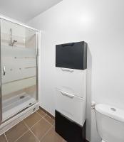 a white bathroom with a toilet and a sink at Joyau de Pantin in Pantin