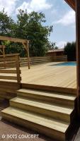a wooden deck with stairs on a house at comme chez vous in Taussat-les-Bains