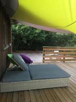 a bed sitting on a deck under a tent at comme chez vous in Taussat-les-Bains