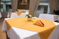 a yellow table with a vase of flowers on it at River View Villa Self Catering in Francistown