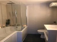 a bathroom with a tub and a toilet and a sink at Morvan La Pastourelle in Quarré-les-Tombes
