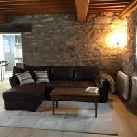a living room with a brown couch and a table at Morvan La Pastourelle in Quarré-les-Tombes