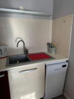 a kitchen with a sink and a red counter top at Appartement T3 bord de la Vienne in Chinon