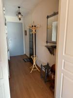 a hallway with a cross on the floor and a mirror at Appartement T3 bord de la Vienne in Chinon
