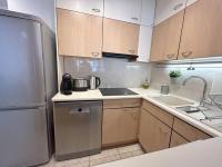 a kitchen with a refrigerator and a sink at Appartement met 2 slaapkamers-VAYA G002 in De Panne