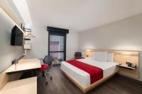 a hotel room with a bed and a desk and a chair at City Express by Marriott Silao Aeropuerto in Silao