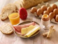 a table with a plate of cheese and eggs and bread at ibis Paris Bastille Faubourg St Antoine in Paris