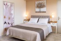 A bed or beds in a room at Aphrodite Superb Sea View Apartment