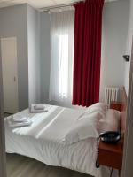 a bedroom with a large bed with a red curtain at Hotel Wilson Square in Toulouse