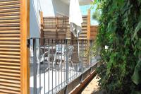 a balcony with a table and an umbrella at Appartement Le Lido de la Marana in Lucciana