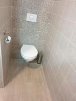 a bathroom with a white toilet in a room at Appartement Le Lido de la Marana in Lucciana