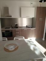 a kitchen with a table with a fan on it at Appartement Le Lido de la Marana in Lucciana