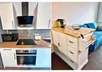 a kitchen with white cabinets and a microwave at Spacieux en Centre Ville in Biscarrosse