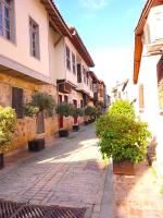 an empty street with potted plants and buildings at Exceptional Studio Flat near Hadrian&#39;s Gate in Antalya