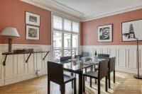a dining room with red walls and a table and chairs at Gorgeous and large flat in the heart of Paris 09 in Paris