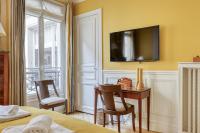 a bedroom with a desk and a tv on the wall at Gorgeous and large flat in the heart of Paris 09 in Paris